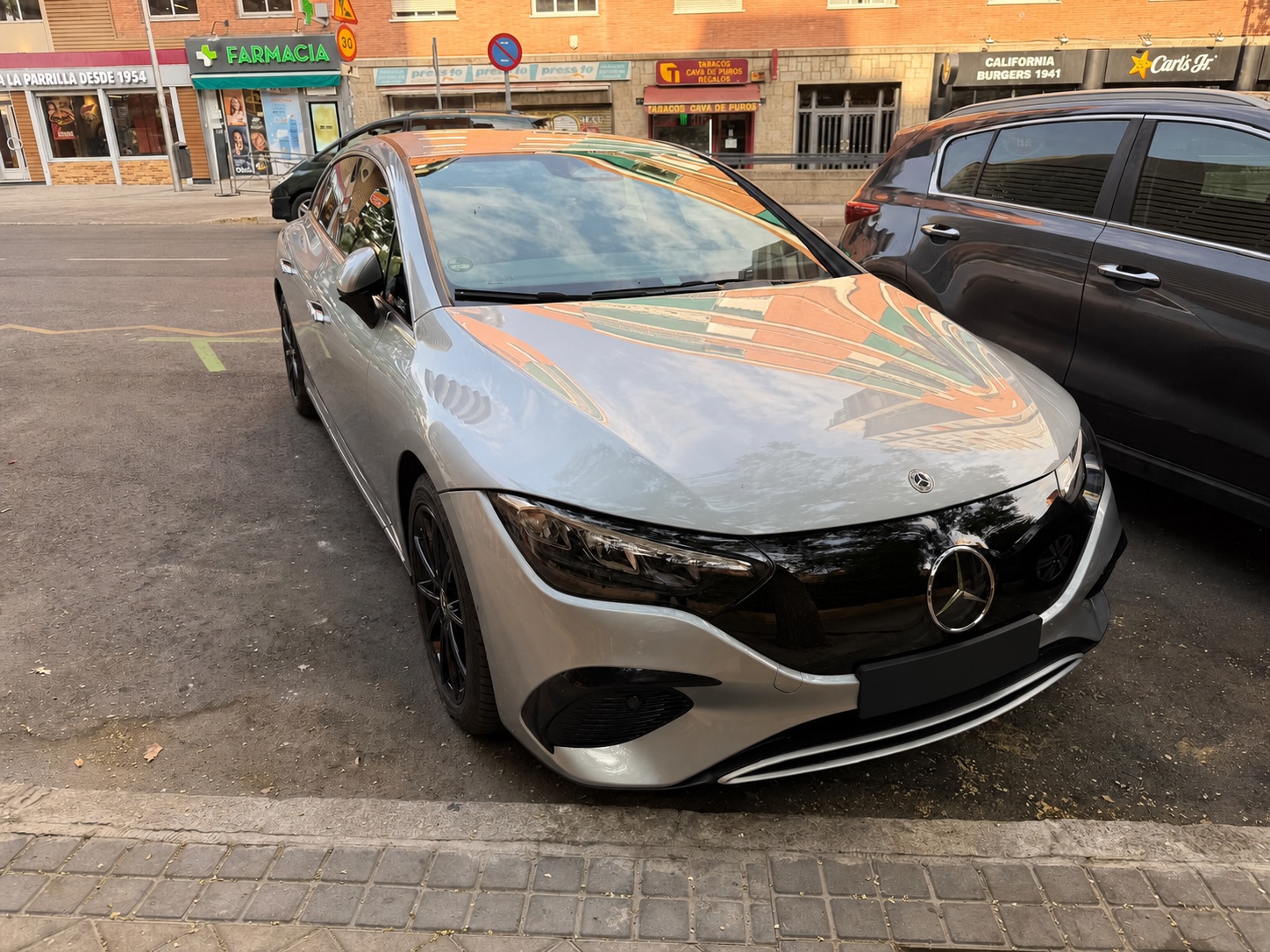 Silver Mercedes EQE executive transfer car viewed from the front