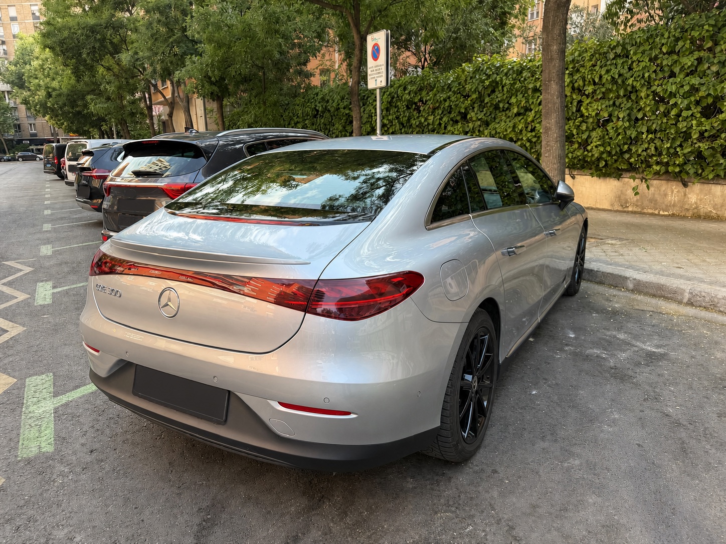 Silver Mercedes EQE executive transfer car viewed from the rear