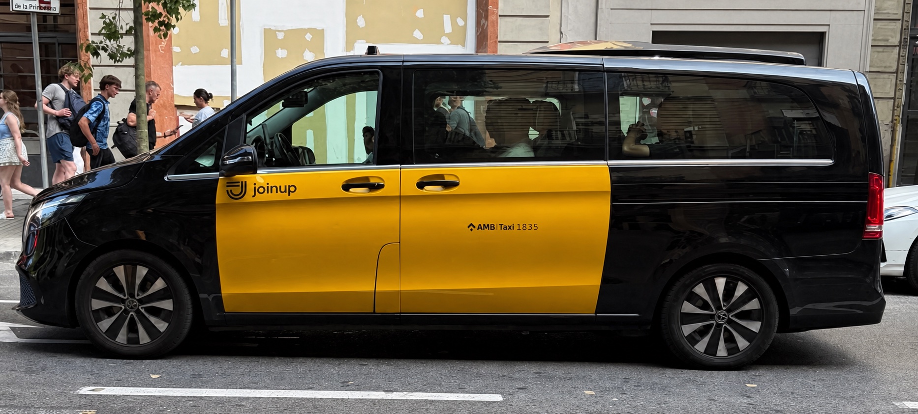 Licensed black and yellow Mercedes V-Class taxi van for group transfers in Barcelona
